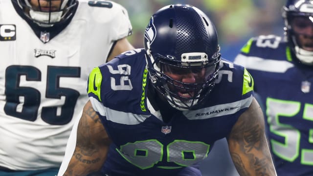 Seattle Seahawks defensive end Leonard Williams (99) tackles Philadelphia Eagles running back D'Andre Swift (0) for a loss during the first quarter at Lumen Field.